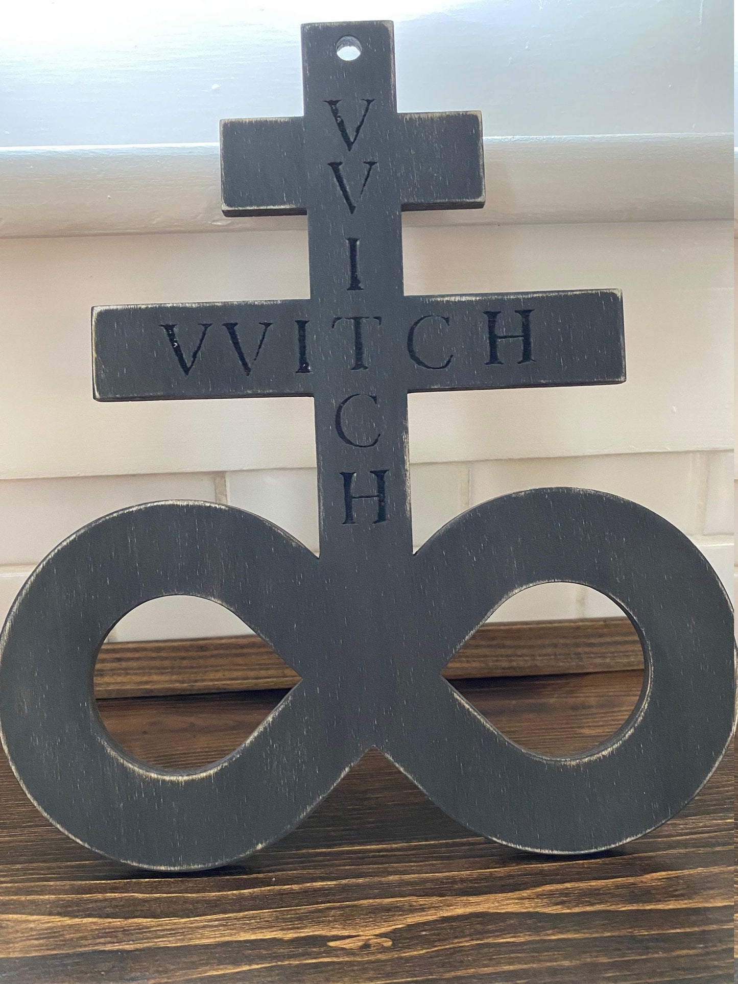 Black on black hanging Brimstone symbol with "VVITCH" engraved.