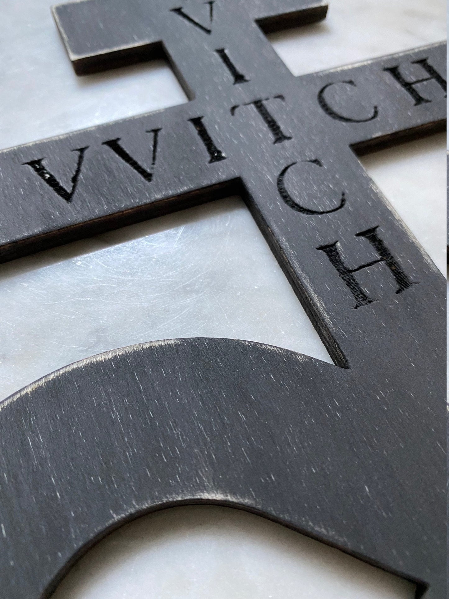 Black on black hanging Brimstone symbol with "VVITCH" engraved.