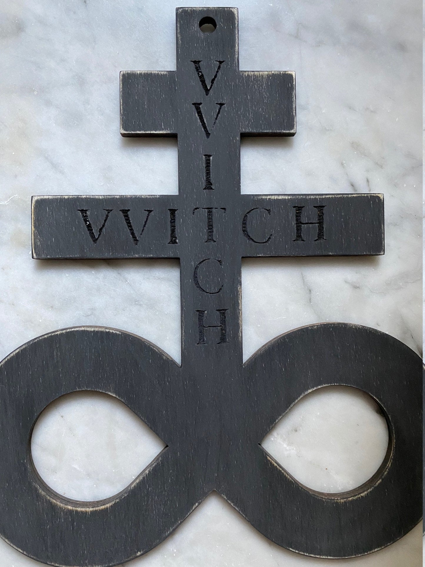 Black on black hanging Brimstone symbol with "VVITCH" engraved.