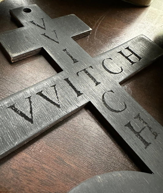 Black on black hanging Brimstone symbol with "VVITCH" engraved.